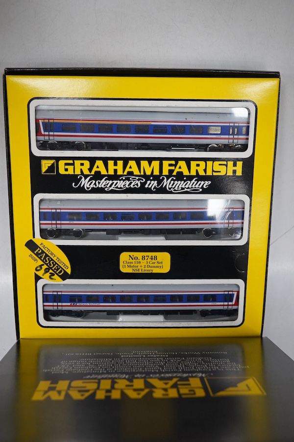 Four boxed Graham Farish N gauge railway train packs; two BR Regional Railways Class 158 2-car DMUs (8707), plus additional 2-car coach set (0887), and a Network SouthEast Class 159 3-car DMU (8748). Condition - good.